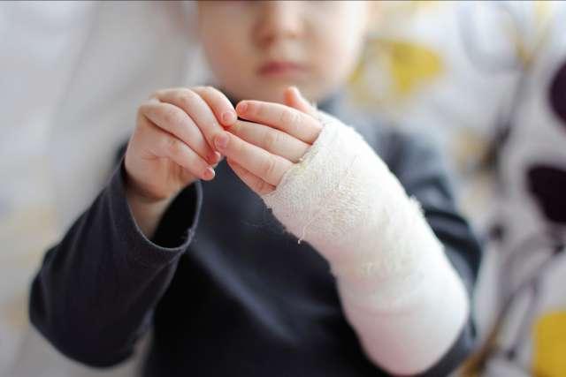 Little girl showing her bandaged hand