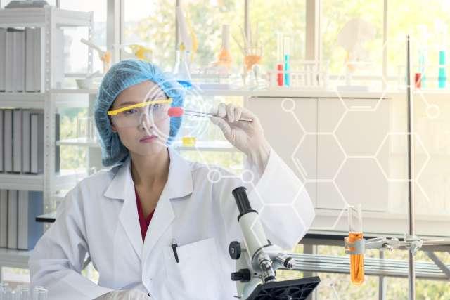 Cancer researcher holding test tube in lab
