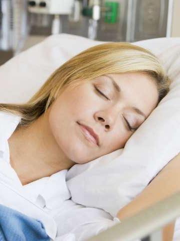 Woman sleeping in a hospital bed